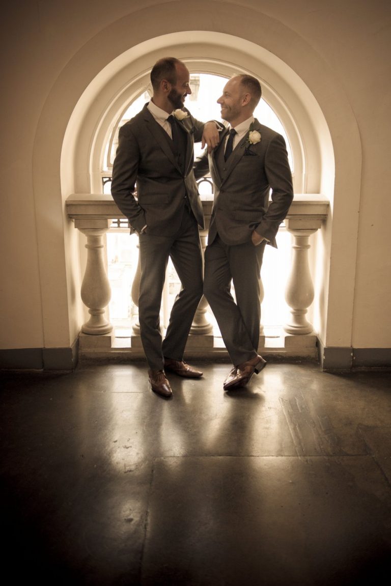 London wedding same sex grooms gaze at each other