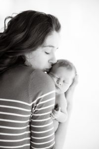 mum kisses newborn