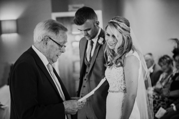back and white photo of grandad doing a reading at the wedding