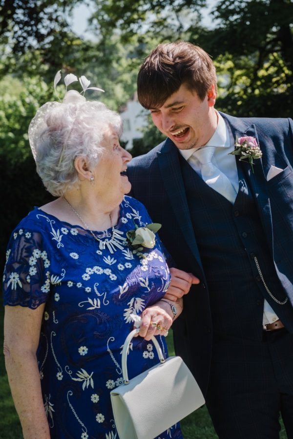 grandma and grandson share a laugh at the wedding