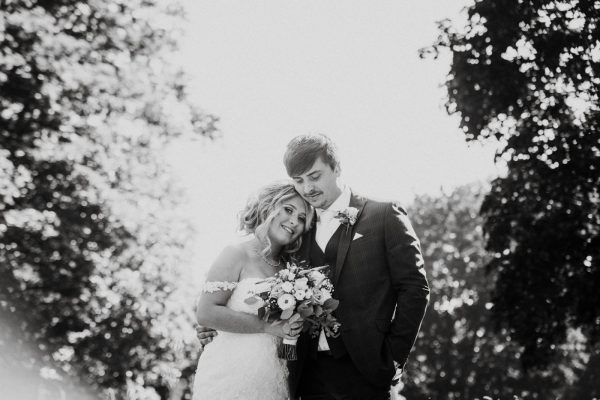black and white image of couple surrounded by trees
