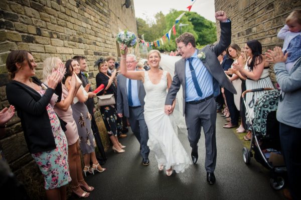 bride and groom celebrate with village