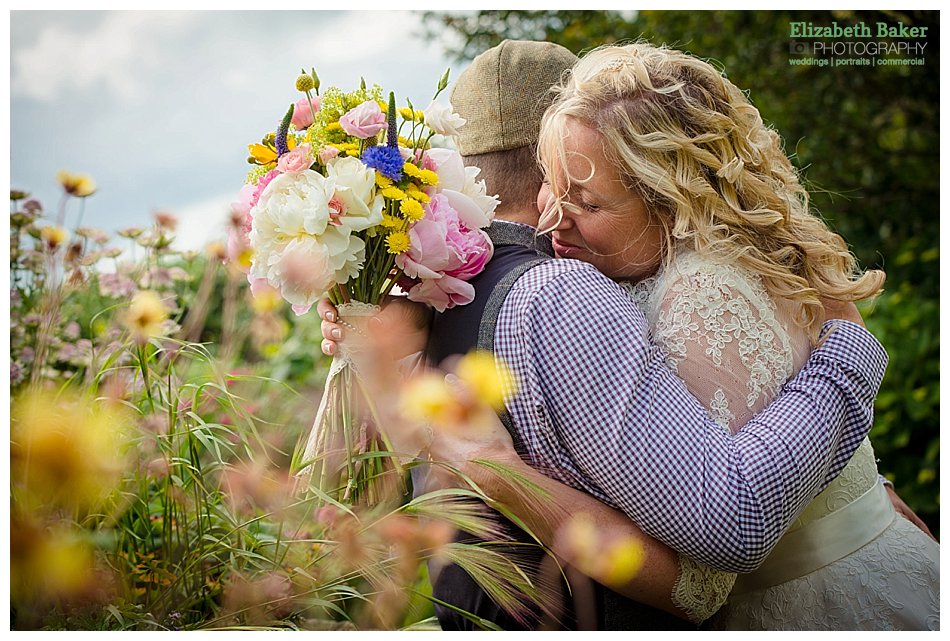 newlyweds hugging flowers