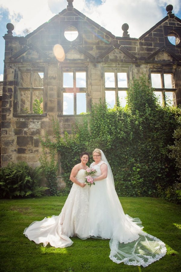 two brides outside historic East Riddlesden Hall