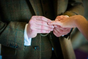 groom gives ring to the bride
