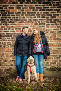 leaning on wall, smiling couple