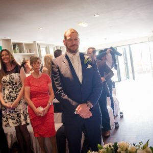 groom waits at top of aisle