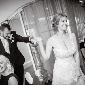 bride leads the groom into the reception