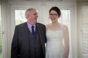 dad and bride share a joke