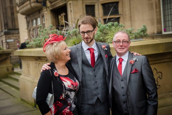 groom and parents in suits
