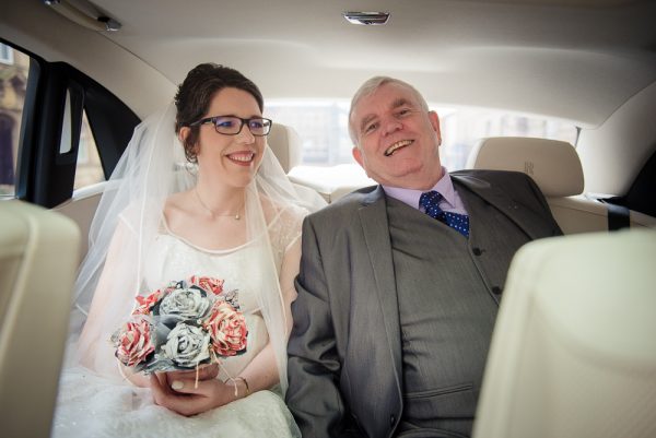 bride and dad in wedding car