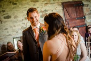 groom looks at bride during wedding service