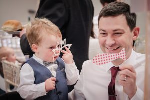 guests playing with Photo Booth props