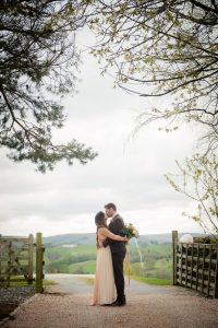 new mr and mrs underneath trees kissing
