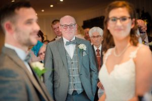 dad looks on to ceremony
