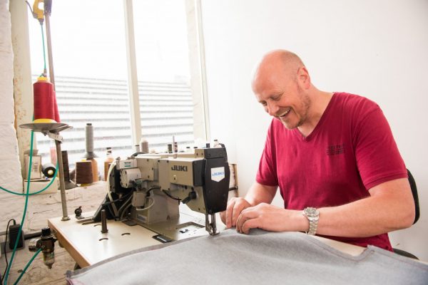 Huddersfield businessman working at the sewing machine