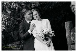black and white capture of groom behind bride