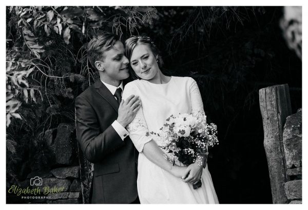 black and white capture of groom behind bride