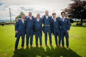 groomsmen standing in sun dark shadows