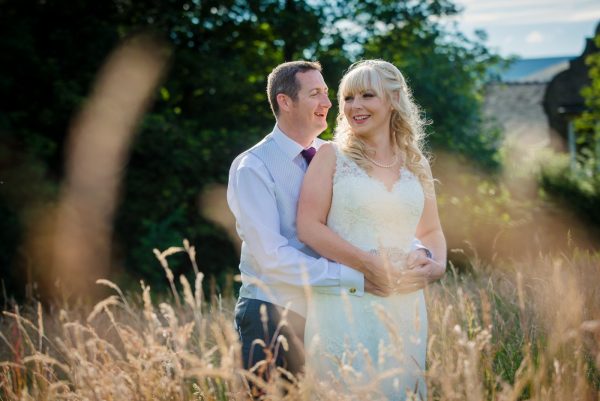 bride and groom in field long grass