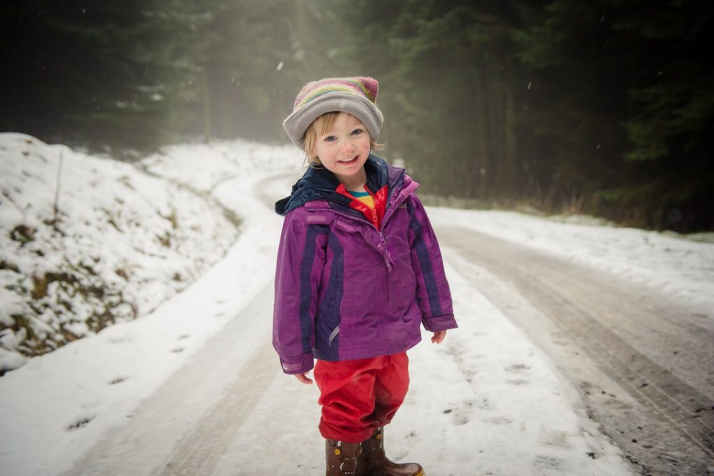 little girl looks at camera in the snow