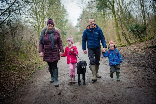 family walking along wooded path