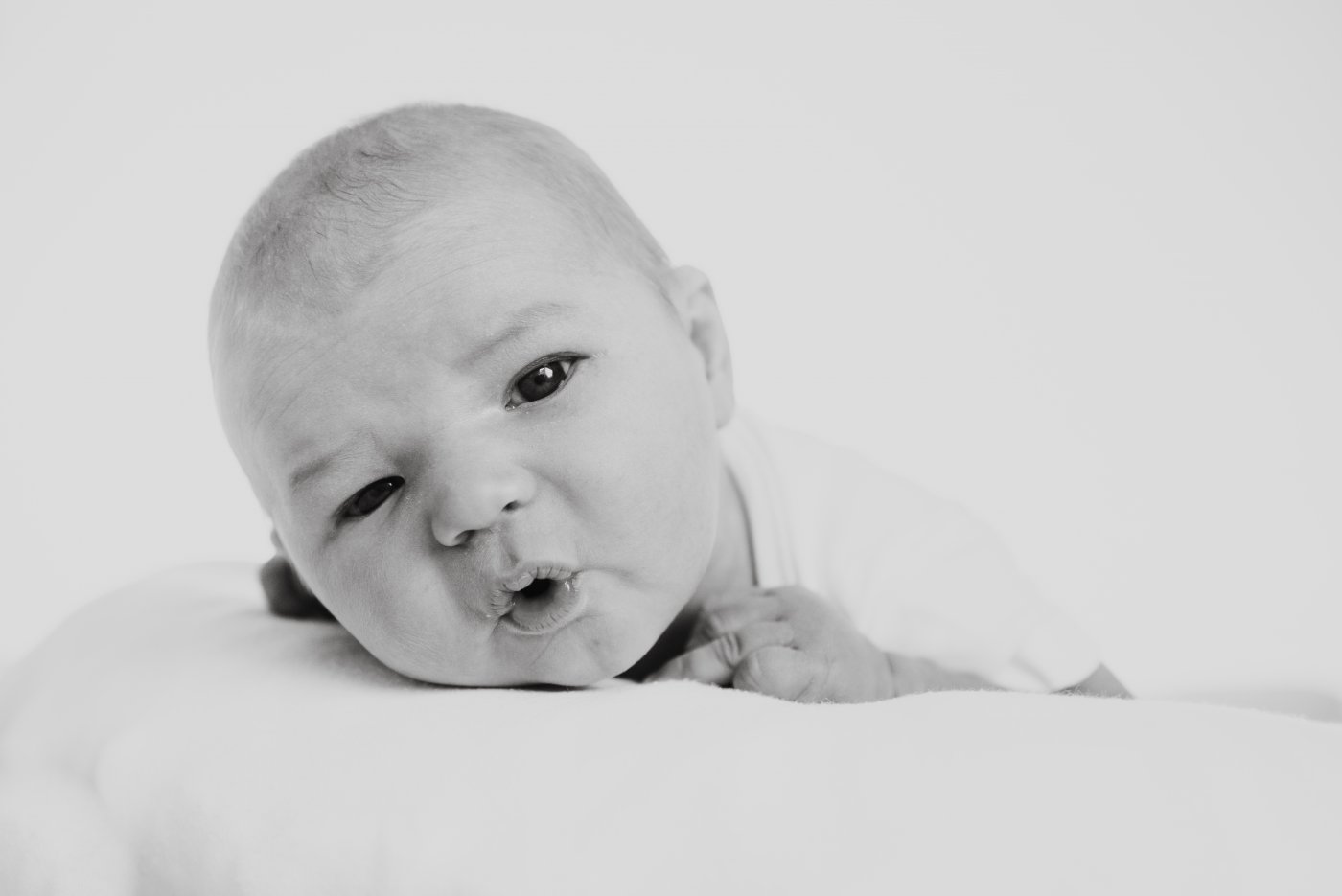 black and white of baby looking at camera