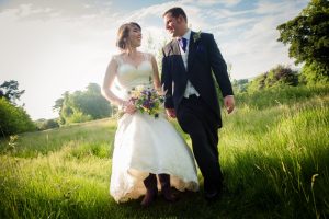 wellies on bride walking through field