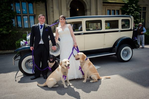 bride and groom with dogs and car outside bagden hall