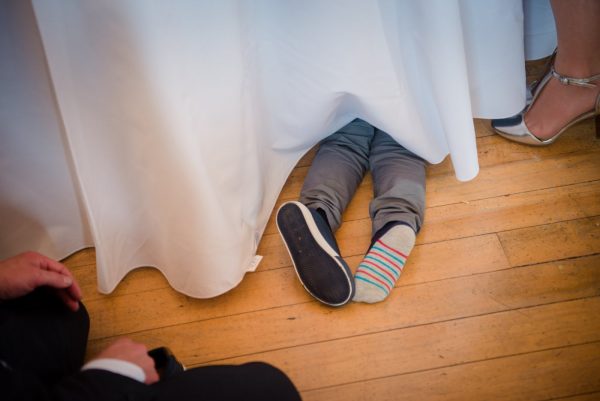 funny photo of a child disappearing under the table