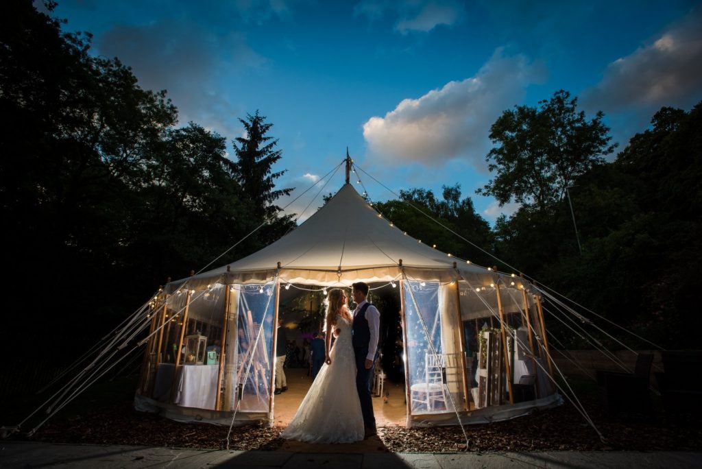nighttime photo of the newlyweds under the marquee
