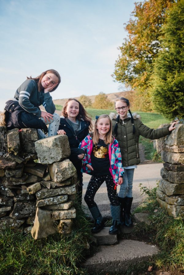 girls posing by yorkshire wall