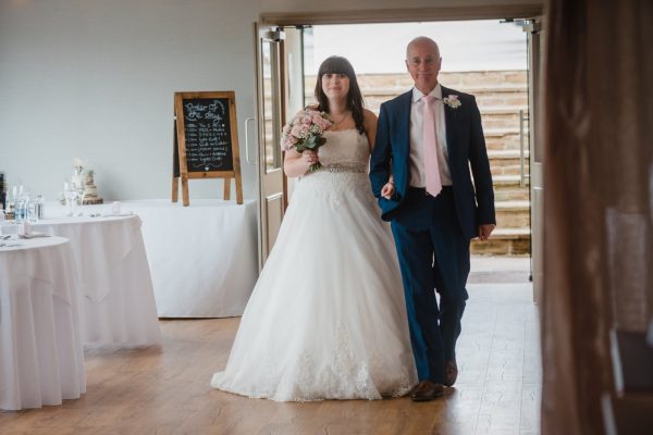 bride and dad walking down the aisle at The Fleece