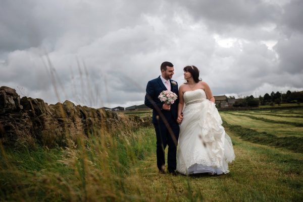 colour image of newly married couple in field Yorkshire