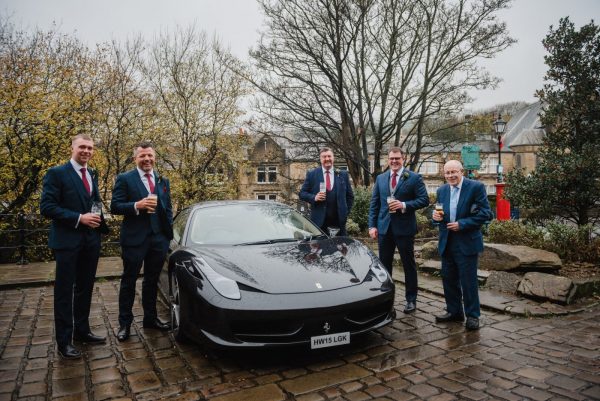 wedding car and groomsmen outside the pub