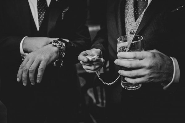 black and white photo close up of the bridegrooms pocket watch