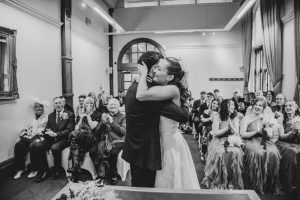 black and white photo of the bride and groom's first kiss