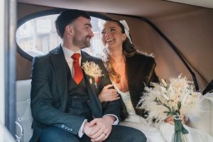 newlyweds in the wedding car after the ceremony
