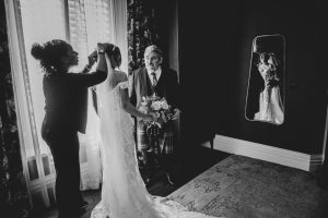 bride and father of the bride meet before the ceremony. Black and white image with mirror reflection.